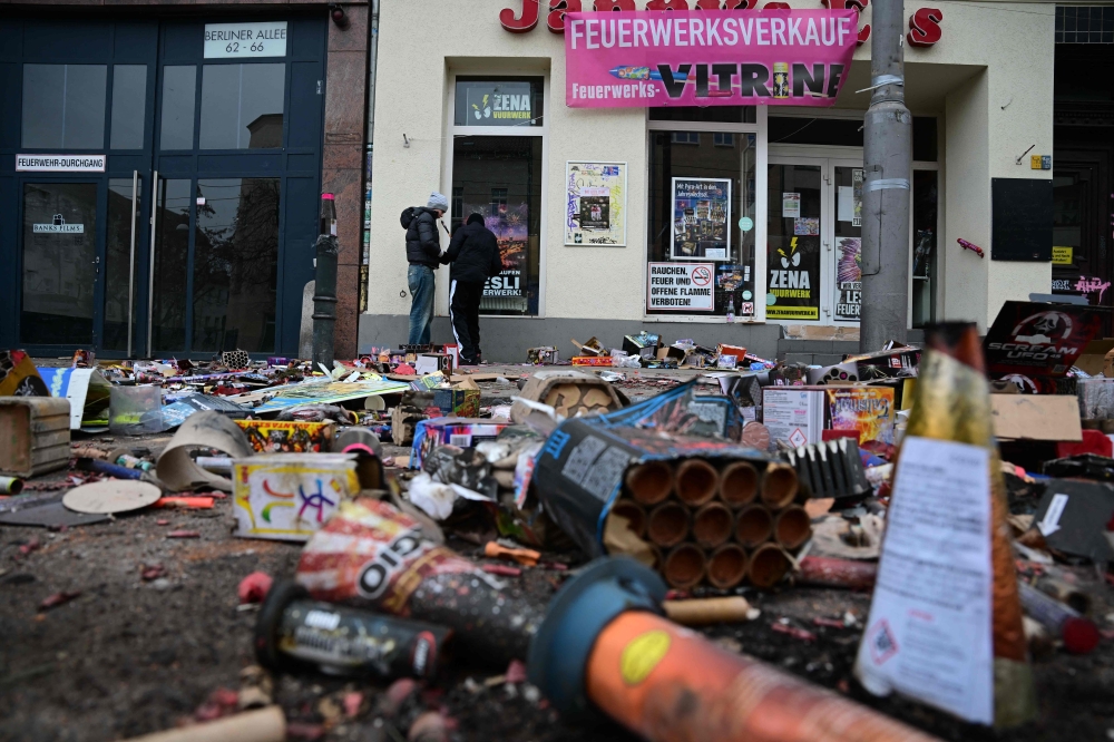 More than 100 police officers were reported injured nationwide. Fireworks remnants on a street in Berlin. — AFP pic