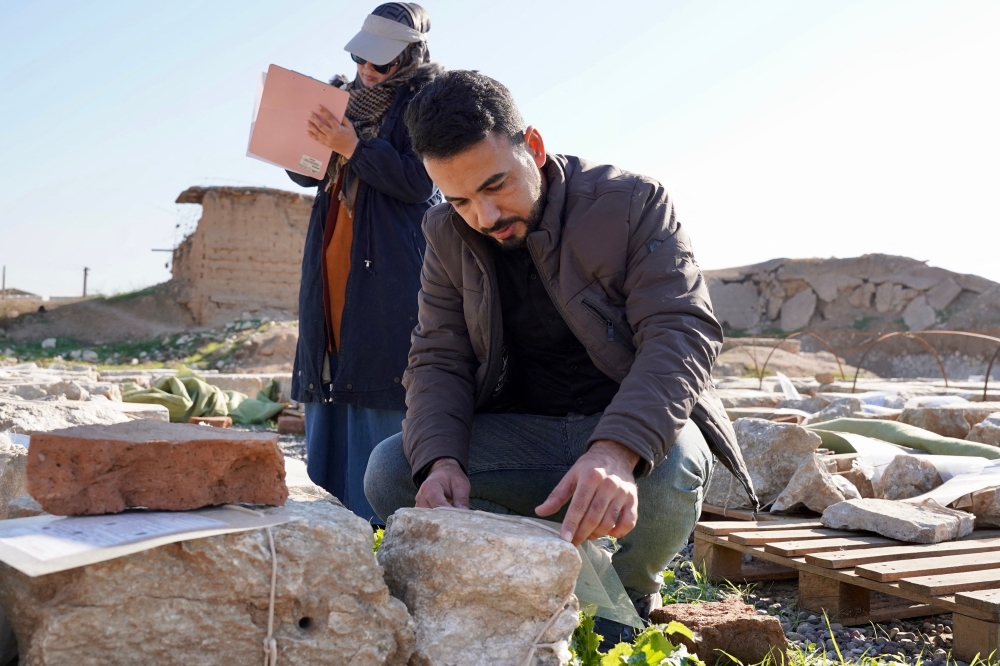 Archaeology experts catalogue destroyed archaeological artefacts at the archaeological site of Nimrud, south of Mosul, on January 3, 2025. — AFP pic