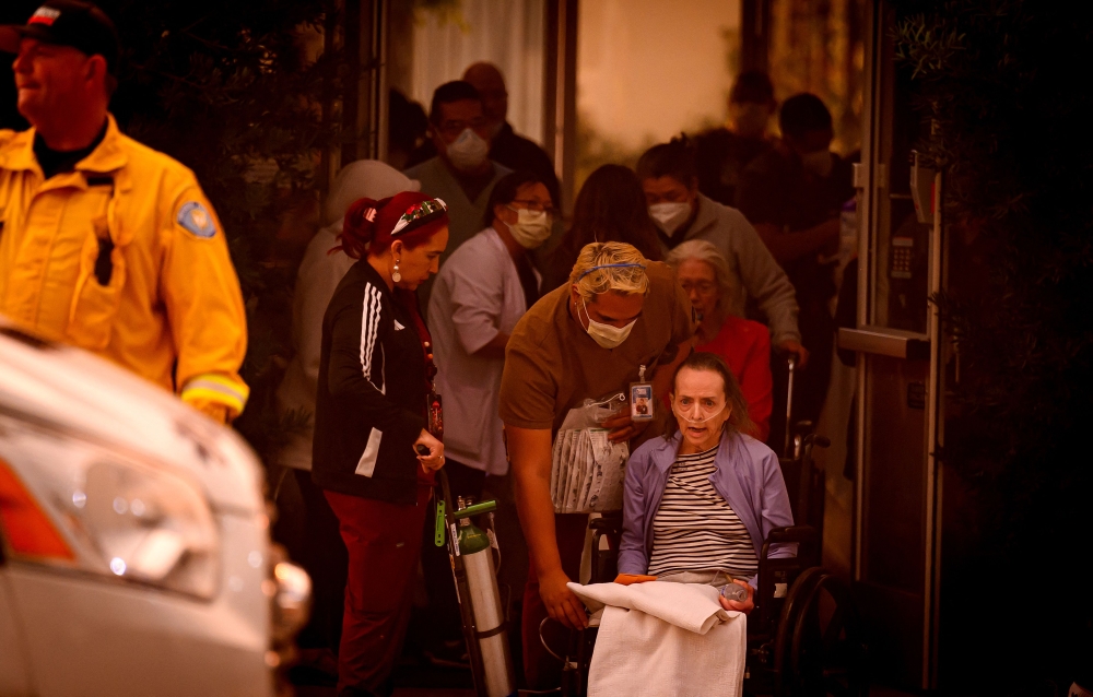 Patients are evacuated from the Brighton Care Center in Pasadena. — AFP