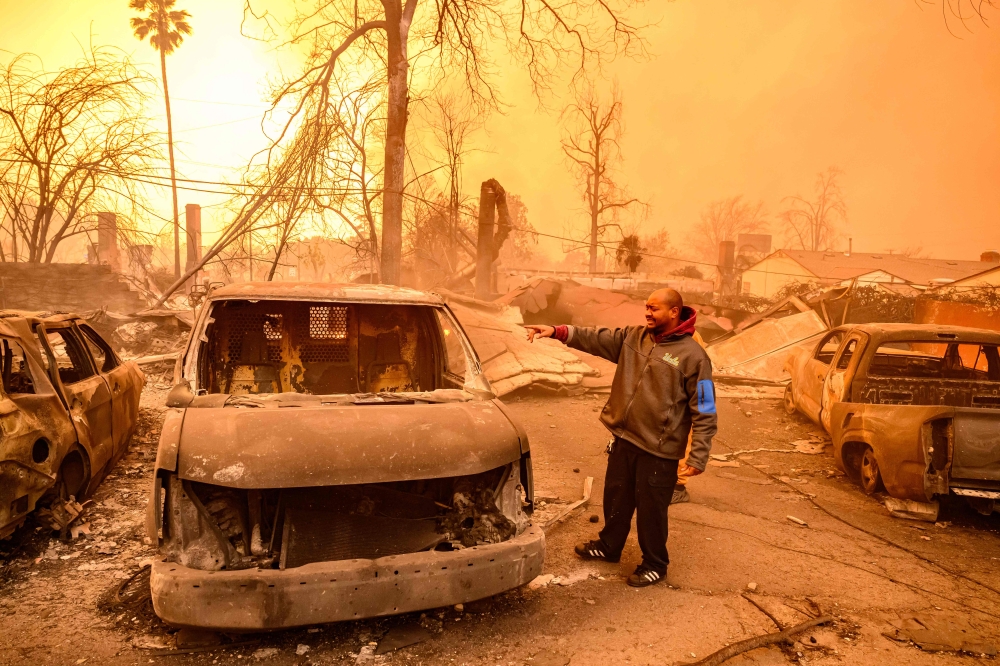 DeJohn Jones views the remains of his burned home in the Altadena area of Los Angeles county. — AFP