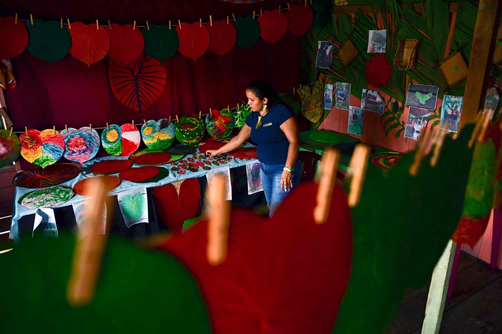 Decleuma Seriaco Gomes shows rubber handcrafts at her home on the Anajas riverbank, municipality of Anajas, contained in the Marajo Archipelago Environmental Protection Area, Para state, Brazil on December 6, 2024. — AFP pic