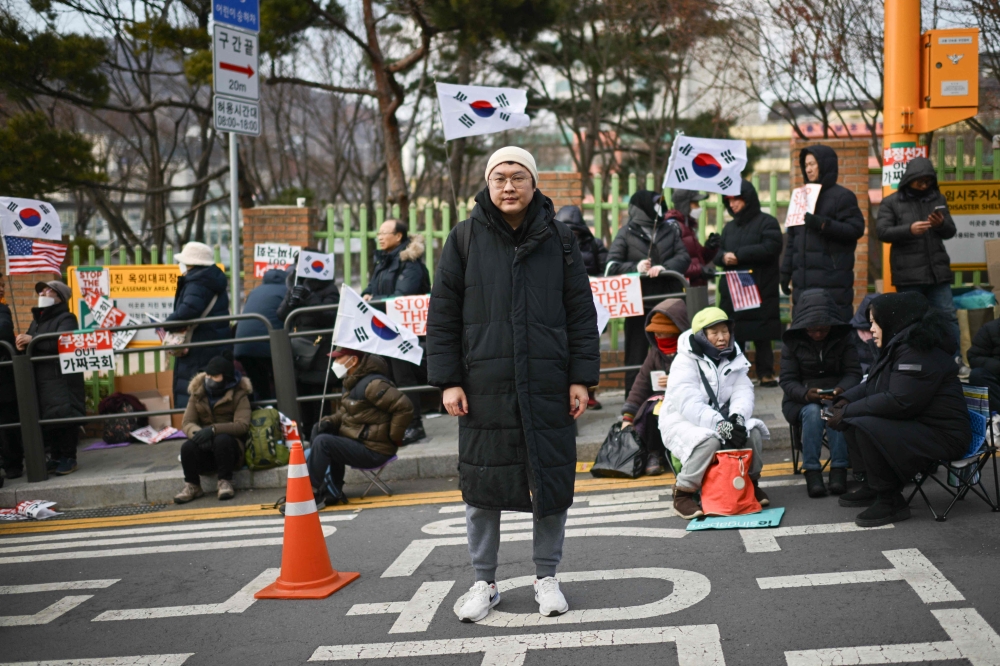 Kim Seung-bin, 38, a supporter of impeached South Korea president Yoon Suk-yeol poses during a rally near Yoon’s residence in Seoul January 8, 2025. — AFP pic