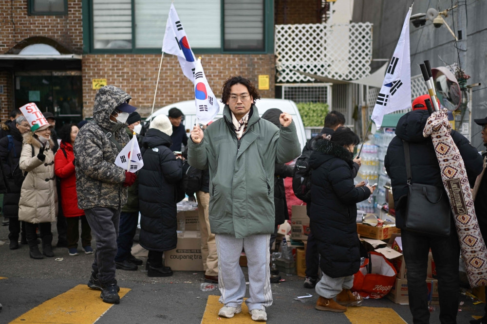 Lee Dong-cheol, 38, a supporter of impeached South Korea president Yoon Suk-yeol poses during a rally near Yoon’s residence in Seoul January 8, 2025. — AFP pic