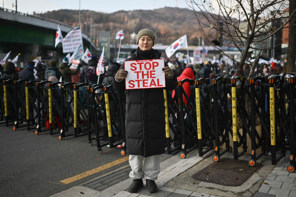 Noh Jong-uk, 39, a supporter of impeached South Korea president Yoon Suk-yeol poses during a rally near Yoon’s residence in Seoul January 8, 2025. — AFP pic