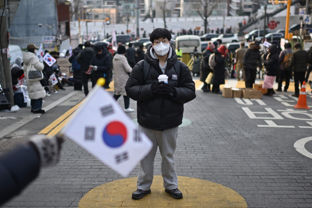 Kim Kyung-jin, 25, a supporter of impeached South Korea president Yoon Suk-yeol poses during a rally near Yoon’s residence in Seoul January 8, 2025. — AFP pic