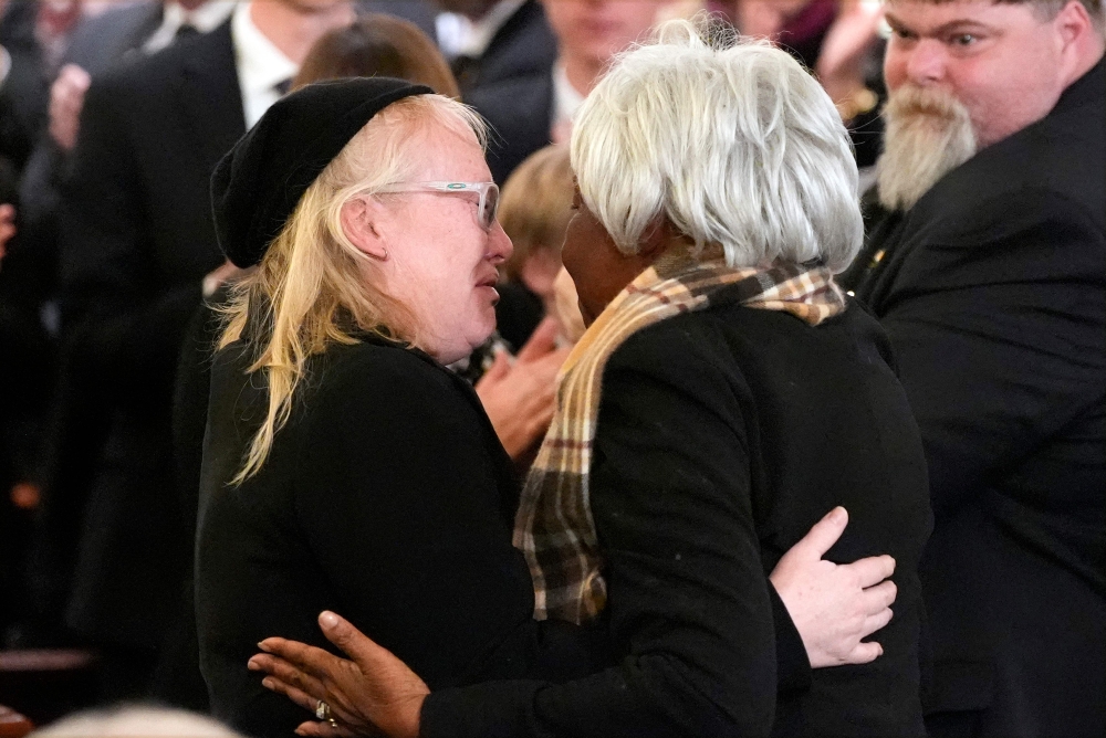 Amy Carter hugs Mary Prince during the funeral service for former President Jimmy Carter. — AFP