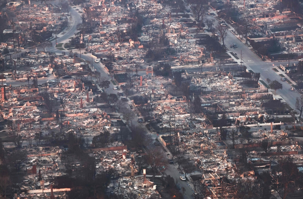 An aerial view shows destroyed homes as the Palisades Fire continues to burn. — AFP