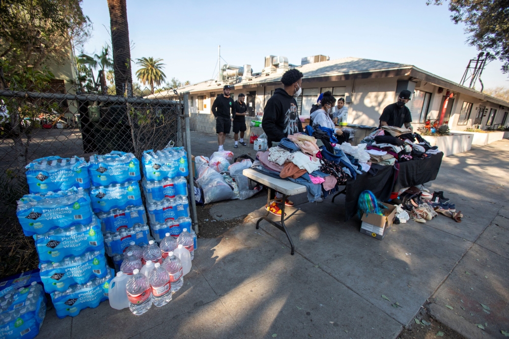 A group of young people gathers to distribute water and clothing to help victims of the Eaton Fire in Altadena, California, January 10, 2025. — Reuters pic