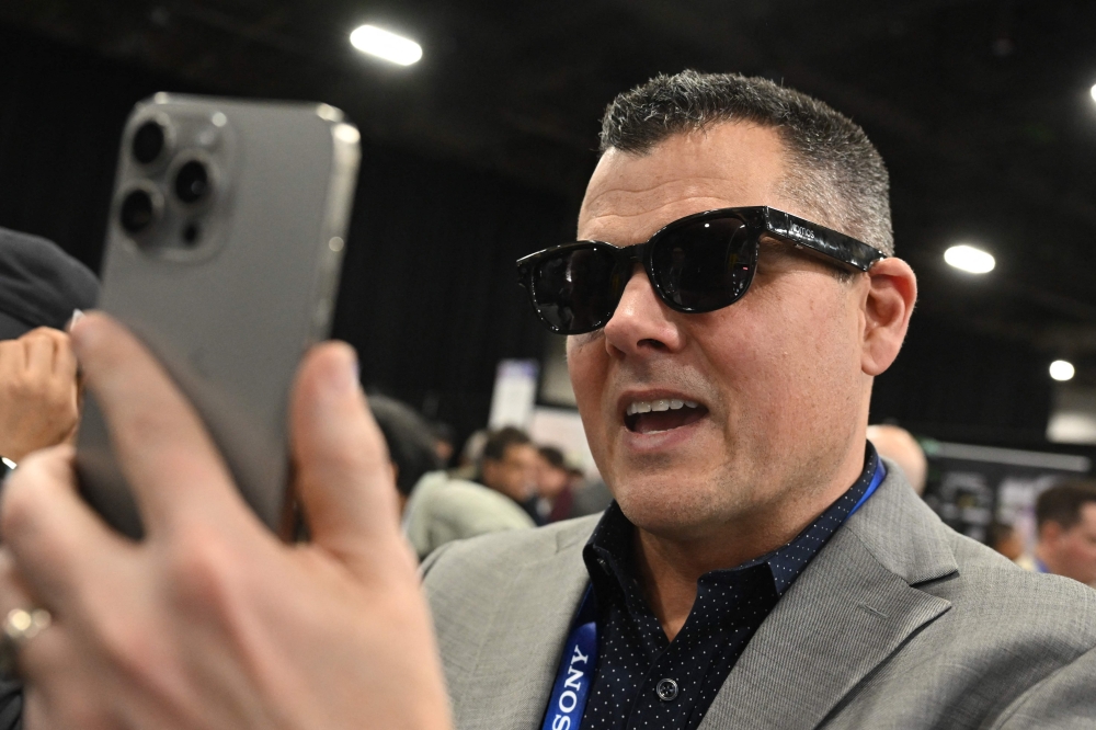 An attendee wears the LOOMOS everyday AI glasses during CES Unveiled ahead of the Consumer Electronics Show (CES) in Las Vegas January 5, 2025. — AFP pic