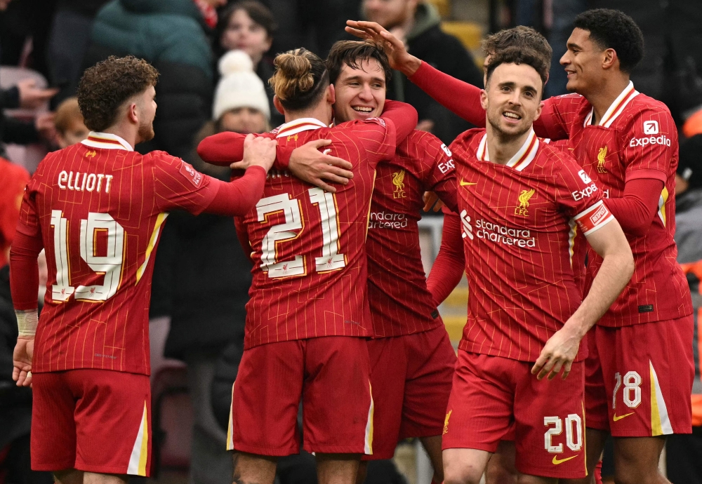 Liverpool’s Federico Chiesa (centre) is mobbed by teammates after scoring the team’s fourth goal. — AFP