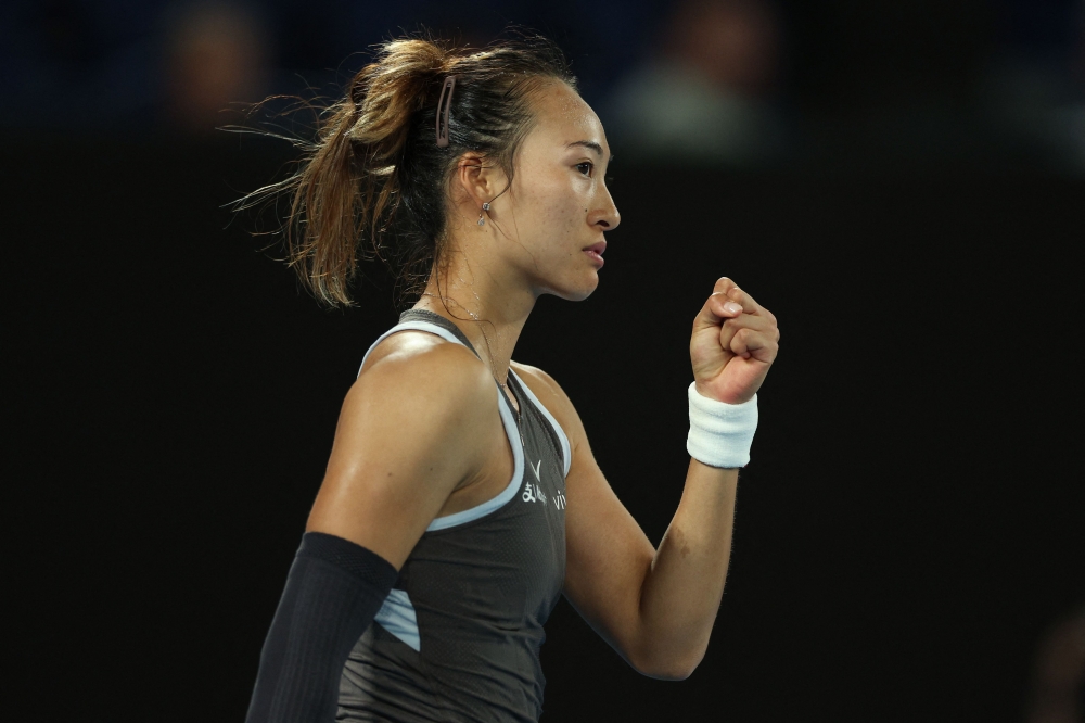 Zheng Qinwen reacts on winning the first set after a tie-break against Romania’s Anca Todoni. — AFP