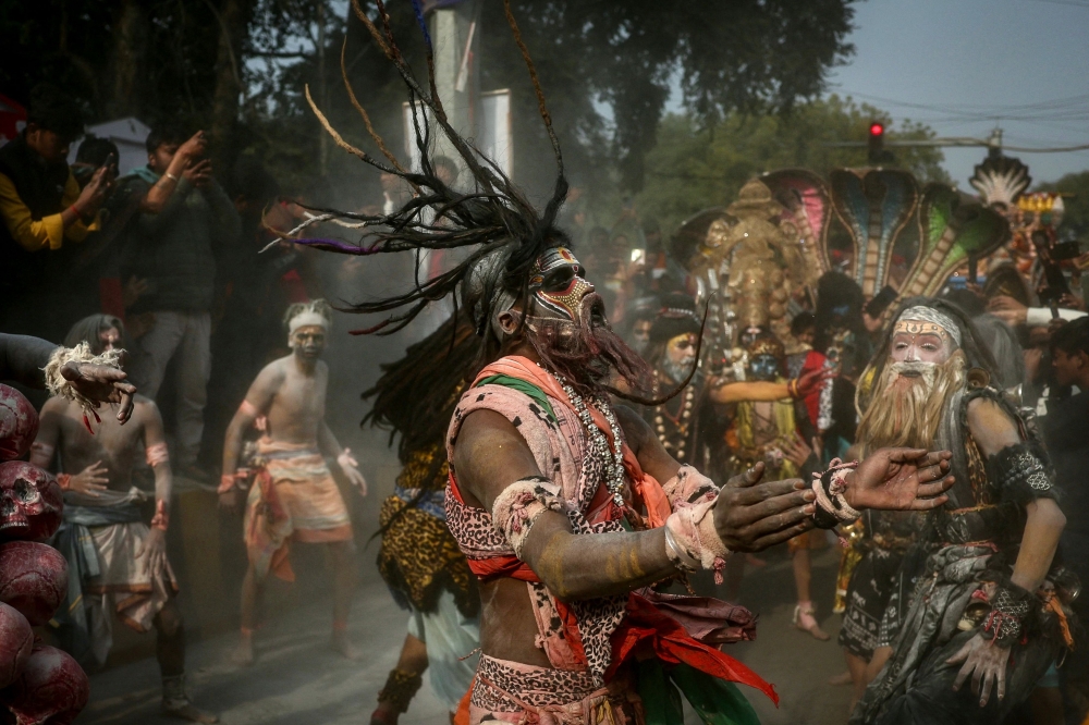 Hindu devotees smeared with ash dance during a religious procession ahead of the Maha Kumbh Mela festival in Prayagraj January 10, 2025. — AFP pic