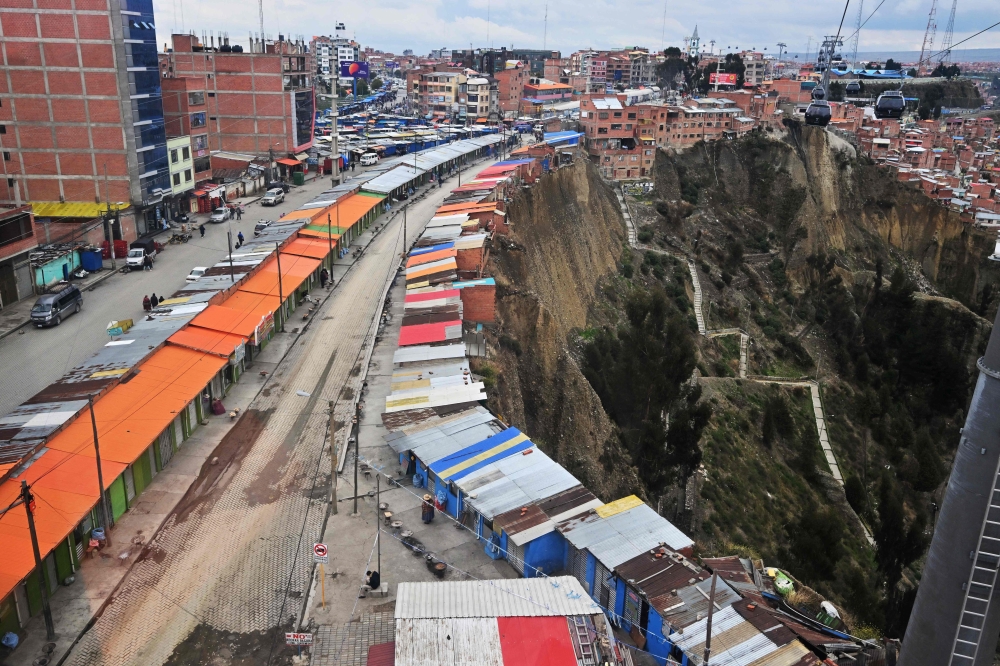 A market built on the edge of a cliff is seen in the La Ceja area of the city of El Alto, Bolivia, on December 9, 2024. — AFP pic