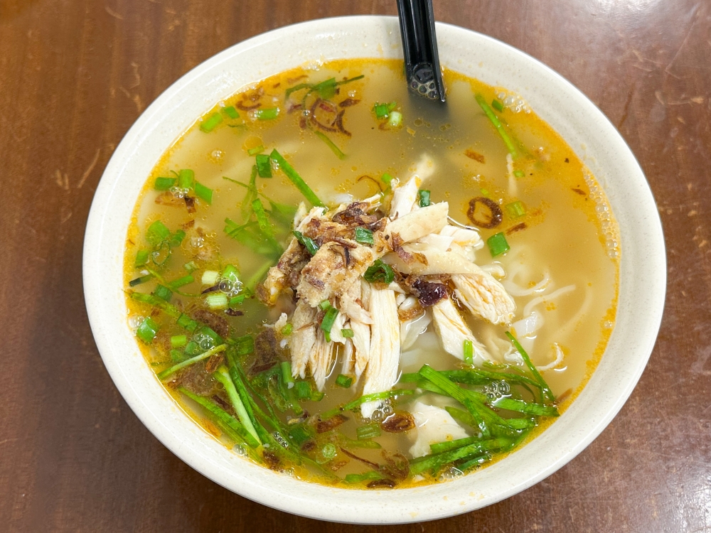 Kai Si Hor Fun delivers with a chicken broth gently touched with prawn oil and smooth flat rice noodles. — Picture by Lee Khang Yi