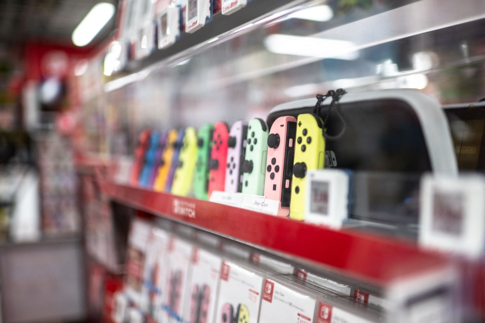 Joypad controllers for the Nintendo Switch are seen for sale in the gaming section of a shop in Tokyo on January 16, 2025. — AFP pic