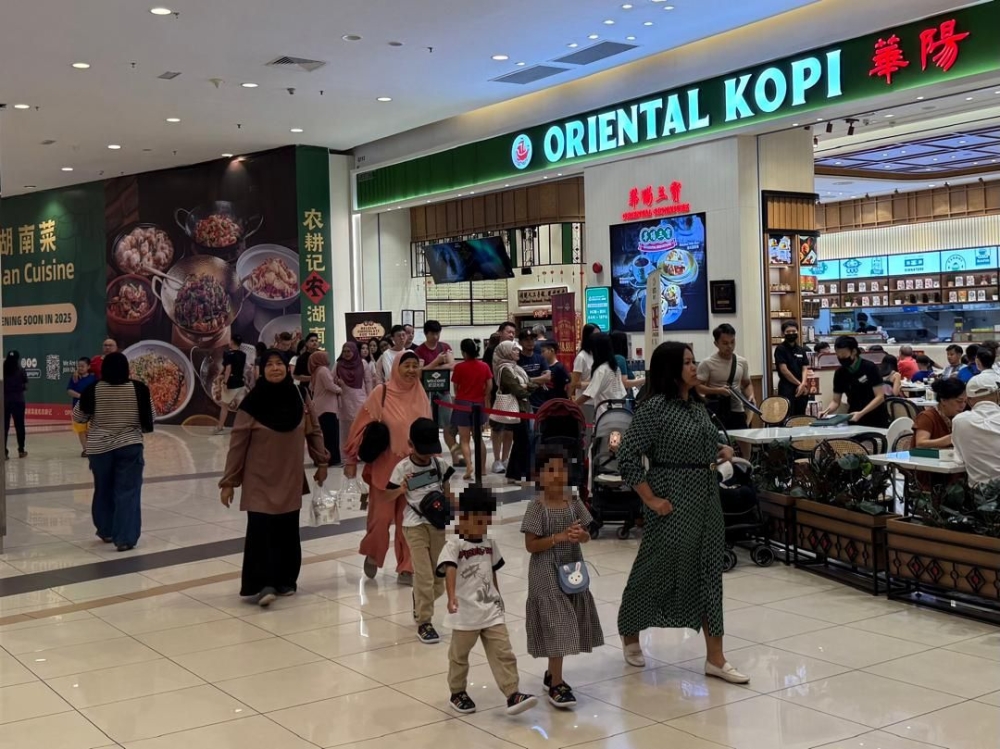 Businesses in Johor Baru city centre anticipate a boost as Singaporeans, who make up a large portion of the state’s visitors, now share the same Saturday-Sunday weekend. — Picture by Ben Tan