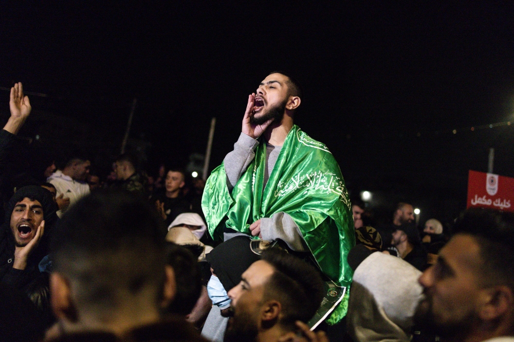 A Palestinian prisoner set free by Israel in the early hours of today celebrates upon his arrival in the occupied West Bank town of Beitunia, on the outskirts of Ramallah. — Pic by AFP