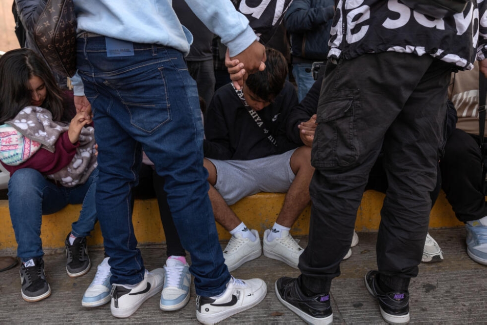 Migrants on the Mexican-US border prayed while waiting for news on their asylum appointments. — Pic by AFP