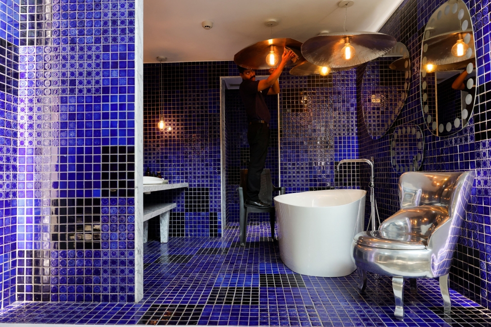 A man cleans inside a sample bathroom at a Kohler experience centre in Mumbai October 17, 2024. — Reuters pic  