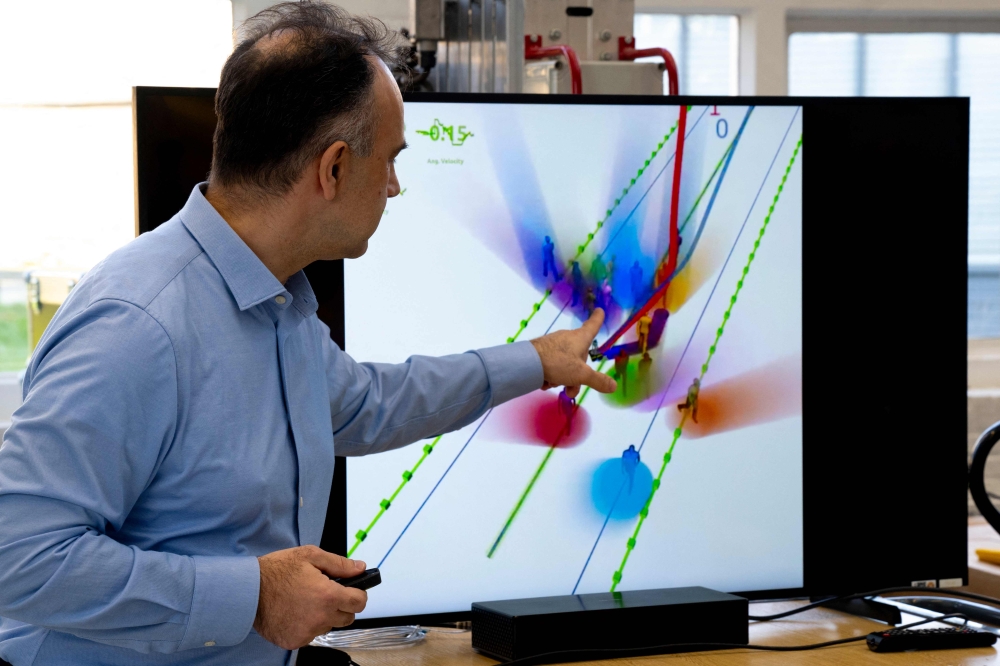 Dutch professor Dr Dariu Gavrila, head of the Intelligent Vehicles section in the Mechanical Engineering Faculty at Delft University of Technology (TU Delft) points to  a screen in Delft, on January 13, 2025. Students from the Delft faculty have developed the TU Delft SenseBike, which can capture its environment and detect objects, such as cars and pedestrians. Using an array of sensors consisting of lidars, cameras, IMU and RTK navigation systems, the SenseBike performs simultaneous localisation and mapping. — AFP pic 