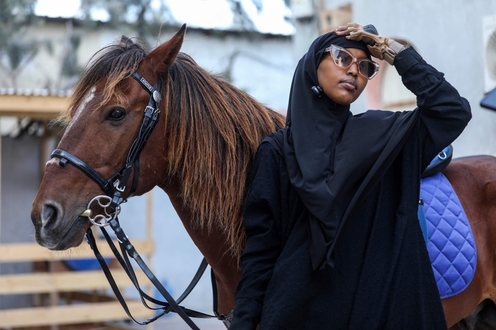 Shukri Osman Muse gets ready to ride her horse in Mogadishu on January 17, 2025. — AFP pic