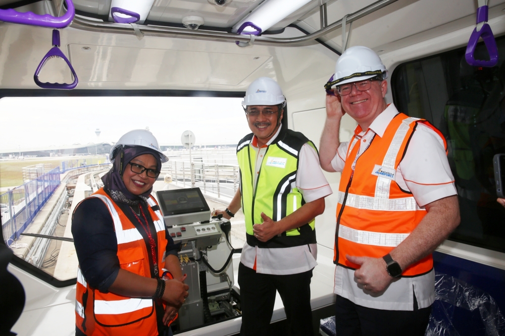 Malaysia Airports Managing Director, Datuk Mohd Izani Ghani with Gordon Stewart (chief operating officer) and Ir Ts Bibi Sabrena Sakandar Khan (KLIA Aerotrain Project Director) in the new KLIA Aerotrain. — Picture by Choo Choy May.