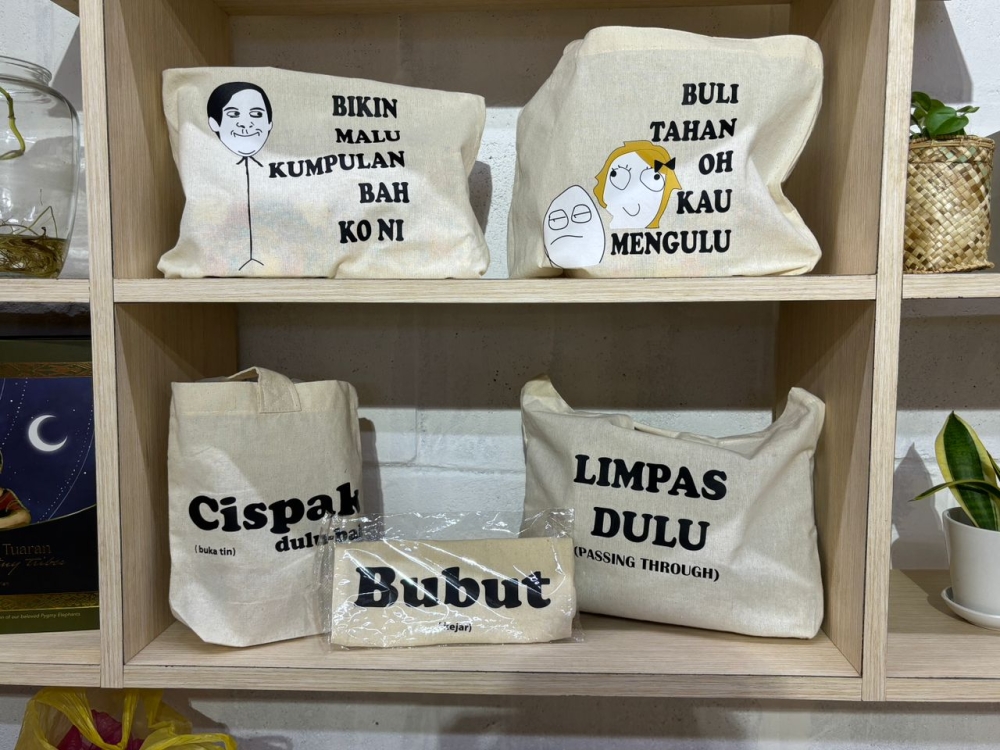 Bags with Sabahan Malay slang on sale at local social enterprise G1FTS in Kota Kinabalu, Sabah. — Picture by Julia Chan