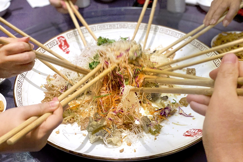 On the seventh day of Chinese New Year, all communities celebrate by tossing ‘yee sang’ – a huge platter of rainbow-hued ingredients to toss together while shouting auspicious sayings. — Picture by CK Lim
