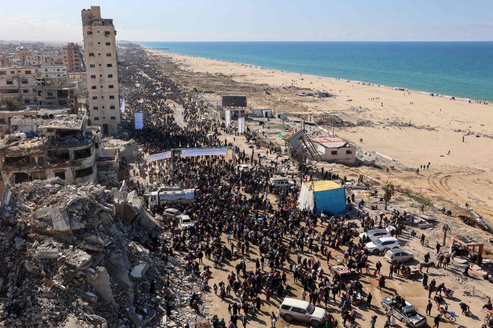 People walk along Gaza’s coastal al-Rashid Street to cross the Netzarim corridor from the southern Gaza Strip into the north on January 27, 2025. Displaced Palestinians began returning to northern Gaza on January 27, an official at the territory’s Hamas-run Interior Ministry told AFP, after a breakthrough in negotiations between Hamas and Israel. — AFP pic 