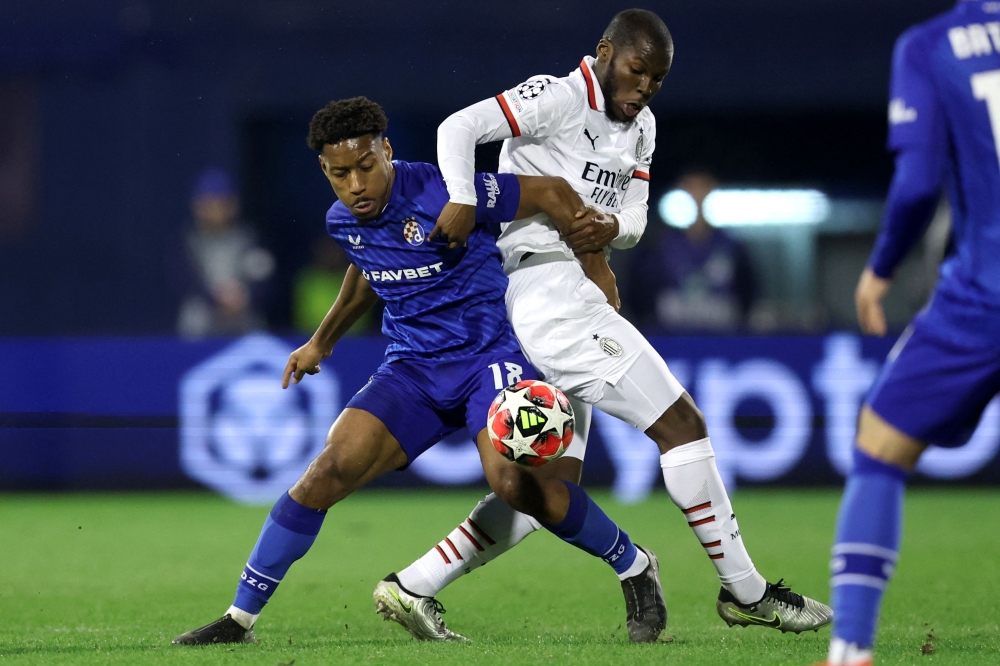 Dinamo Zagreb's French defender Ronael Pierre Gabriel (left) fights for the ball with AC Milan's US midfielder Yunus Musah. — AFP pic