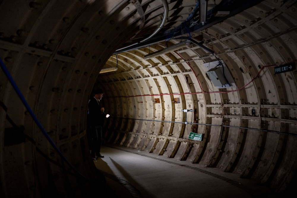 Members of the press are shown around underground tunnels used during World War Two as shelters. — Reuters pic