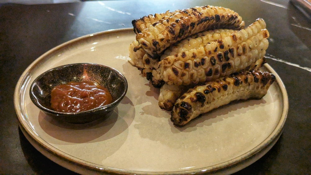 Sweet white corn from Cameron Highlands, grilled with a spicy butter and served with a miso caramel.