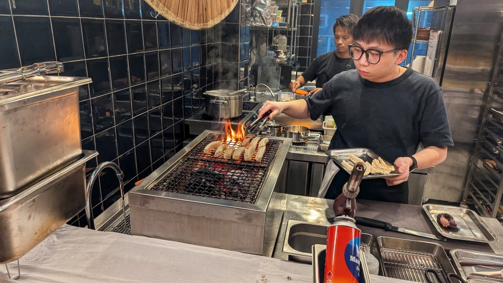 The menu has a grill section, where small plates like corn (pictured here) are prepared.