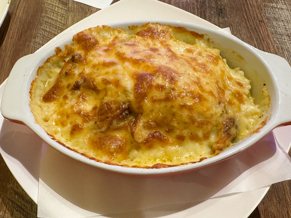 Chicken Baked Rice may look ho hum but you will finish that creamy rice sprinkled with ground black pepper and pieces of rotisserie chicken in a jiffy — Picture by Lee Khang Yi