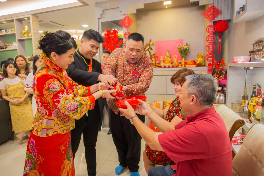 Chong guides a bridal couple through the tea ceremony, which is considered one of the most important rituals in a Chinese wedding. — Picture courtesy of Dary Chong