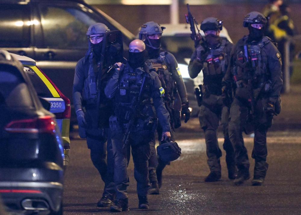 Police special forces are seen leaving the scene of the Risbergska School in Orebro, Sweden, on February 4, 2025, following reports of a serious violent crime. — AFP pic