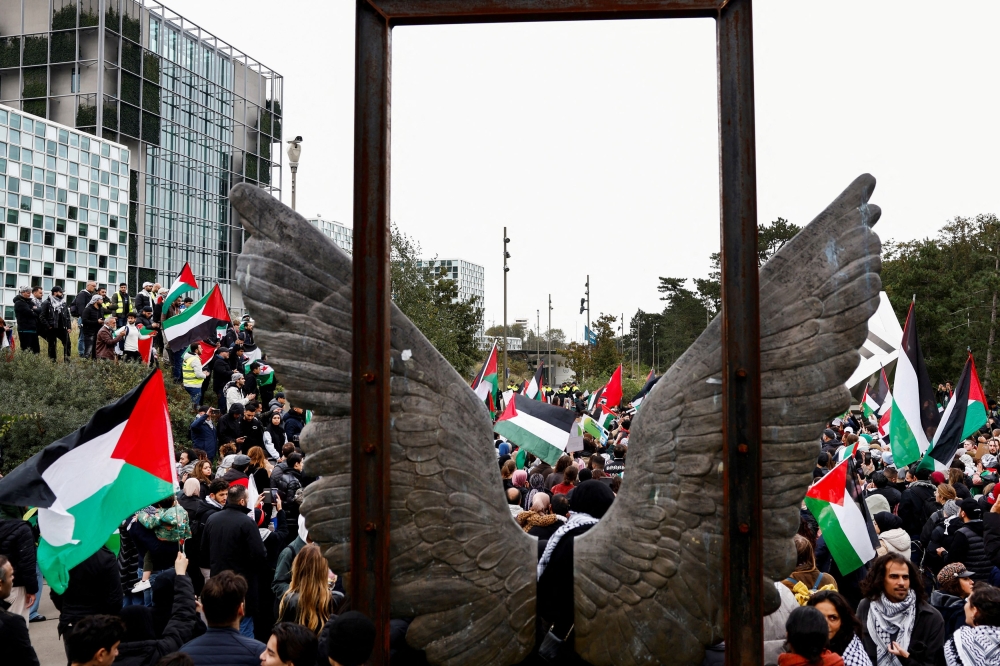 People protest in support of Palestinians in Gaza as the conflict between Israel and Hamas continues, at the headquarters of the International Criminal Court (ICC), which has ongoing investigations into potential atrocity crimes carried out by Hamas in Israel, and by Israelis in the Gaza Strip going back to 2014, and which also covers the current conflict, in The Hague, Netherlands October 18, 2023. — Reuters pic  