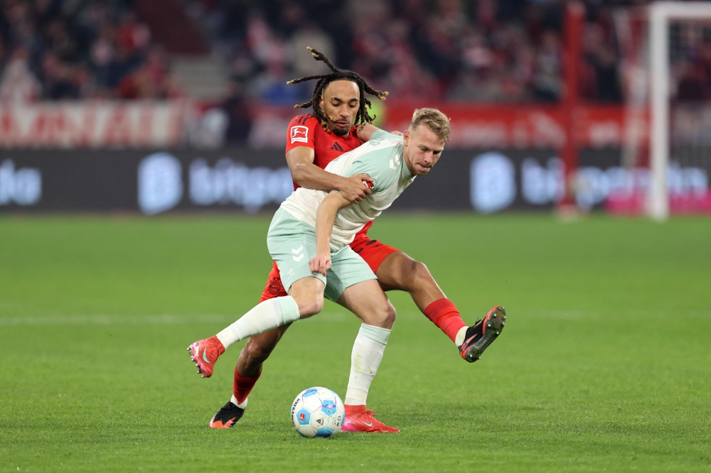 Bremen’s Justin Njinmah (right) and Bayern Munich’s Sacha Boey in action — Pic by AFP