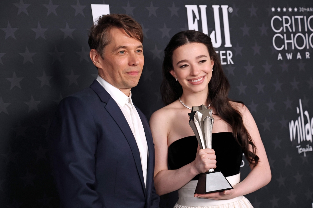 (From left) US director Sean Baker and US actress Mikey Madison pose with the Best Picture award for ‘Anora’ in the press room during the 30th Annual Critics Choice Awards at Barker Hangar in Santa Monica, California February 7, 2025. — AFP pic