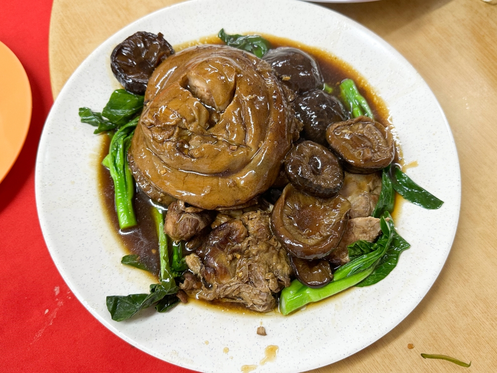 Celebrate with this succulent Braised Pork Knee served with shiitake mushrooms and vegetables. — Picture by Lee Khang Yi