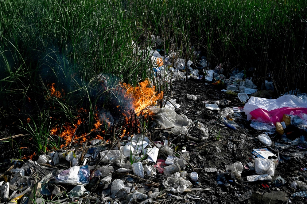 This photo taken on January 30, 2025 shows plastic waste being burned on the outskirts of Phnom Penh. — AFP pic