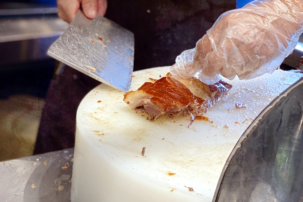 Slicing roast goose to order — Picture by CK Lim