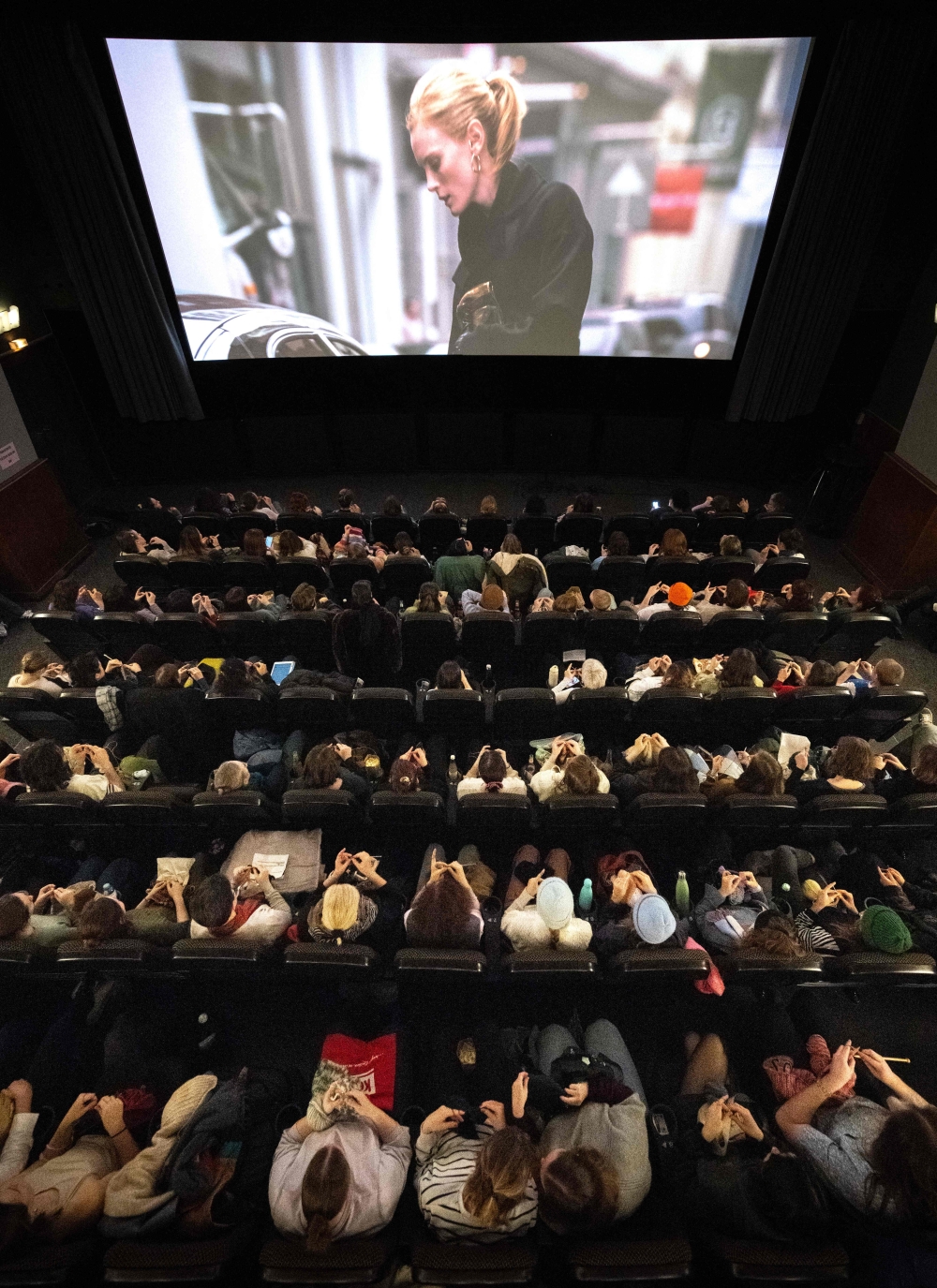 This general overview shhow visitors enjoying their knitting during the projection of the movie ‘The Devil Wears Prada’ at the Votive Cinema in Vienna February 16, 2025. — AFP pic