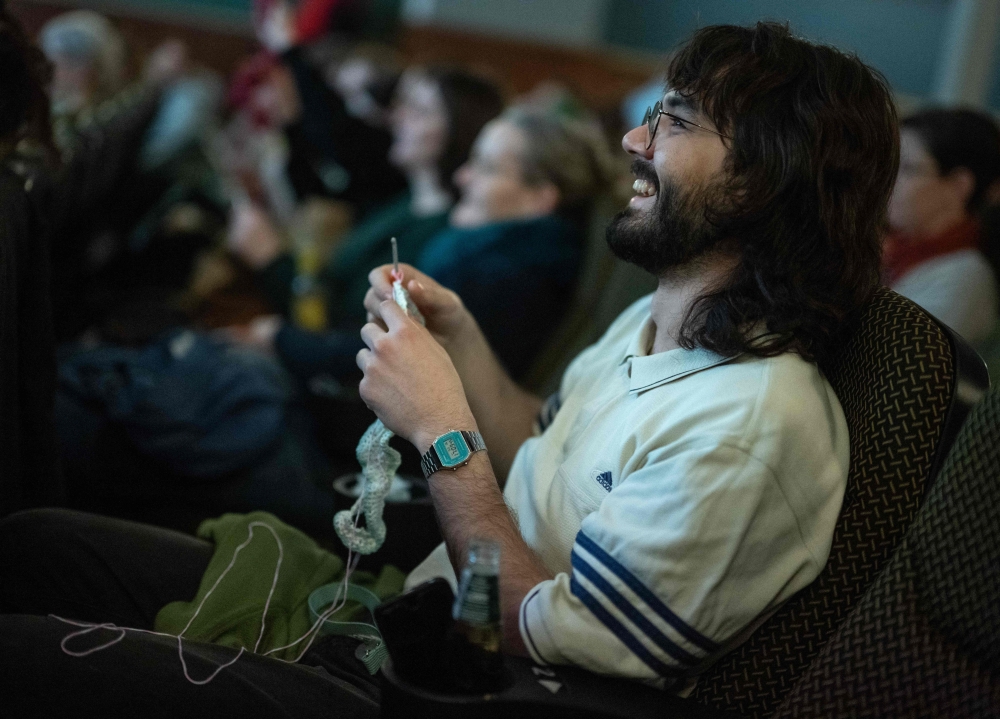 A man knits during the projection of the movie ‘The Devil Wears Prada’ at the Votive Cinema in Vienna February 16, 2025. — AFP pic