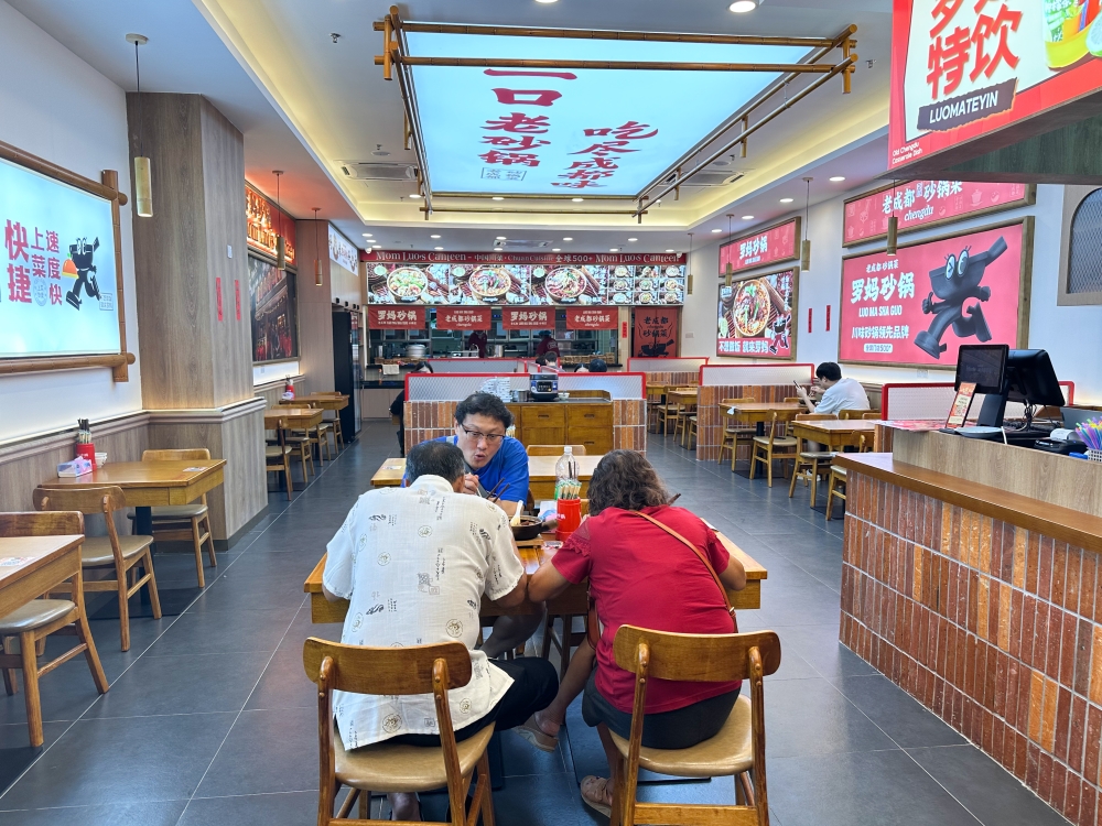 Mak Luo Claypot's interior is peppered with various photos of their signature dishes — Picture by Lee Khang Yi