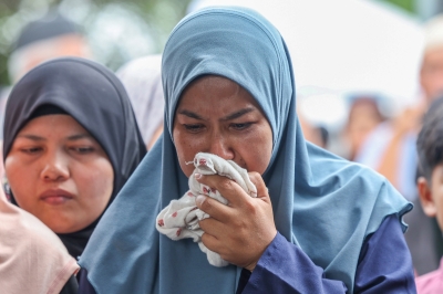 Tears flow as Penang boy, 10, laid to rest after choking on gummy