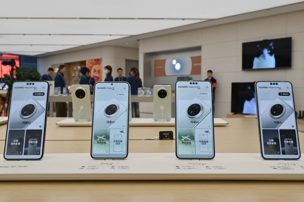 Huawei's new Mate 70 and Mate 70 Pro mobile phones are seen on display inside a Huawei store at the Wangfujing shopping area in Beijing on November 26, 2024.  — AFP pc