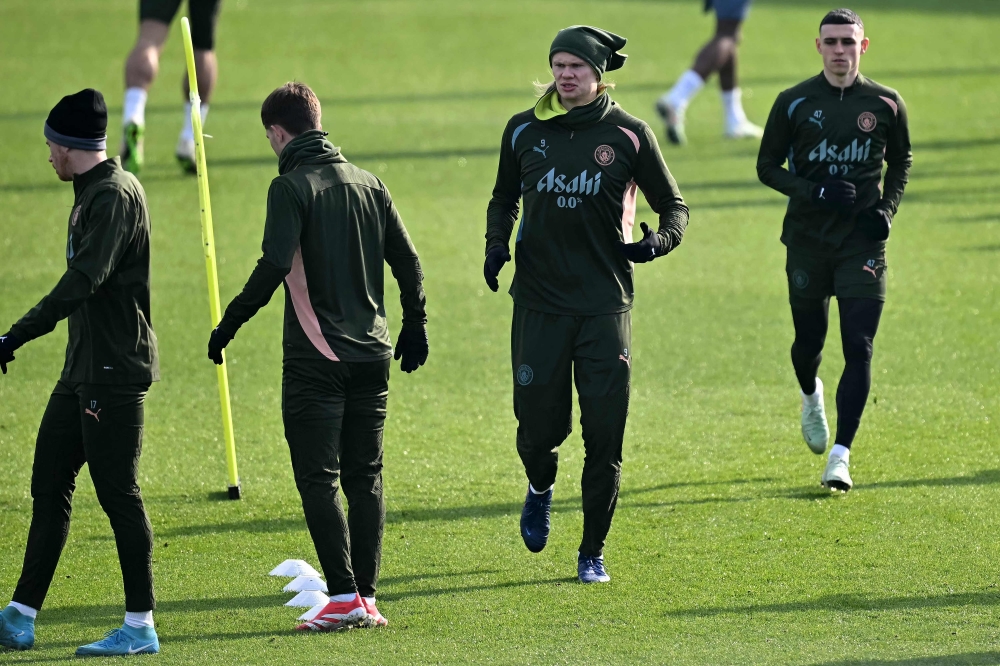 Manchester City’s Belgian midfielder #17 Kevin De Bruyne (left), Manchester City’s Norwegian striker #09 Erling Haaland (2nd right) and Manchester City’s English midfielder #47 Phil Foden (right) take part in a training session at Manchester City’s training ground in Manchester, north-west England, on February 18, 2025, on the eve of their Uefa Champions League second-leg Knockout Round play-off football match against Real Madrid. — AFP pic