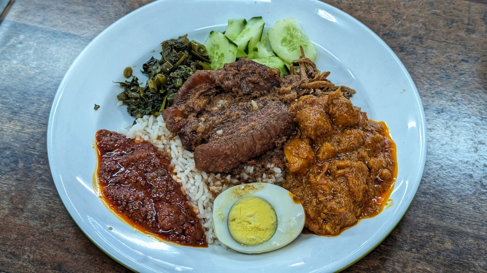 My porky plate of 'nasi lemak' with ‘zha yuk’ and pork ‘rendang’. — Picture by Ethan Lau