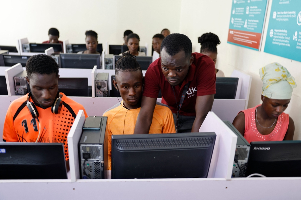 Digi-Hub assistant project officer with CFK Africa (Carolina for Kibera) Gervas Ouma (2nd right), teaches trainees during a class session at the ICT (Information and Communication Technologies) training centre in Kibera, Nairobi on January 22, 2025. — AFP pic 